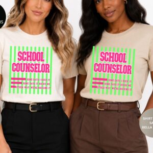 School counselor shirt with pink and green design and the quote Some Days I Rock It, Some Days It Rocks Me, Either Way We’re Rocking It.